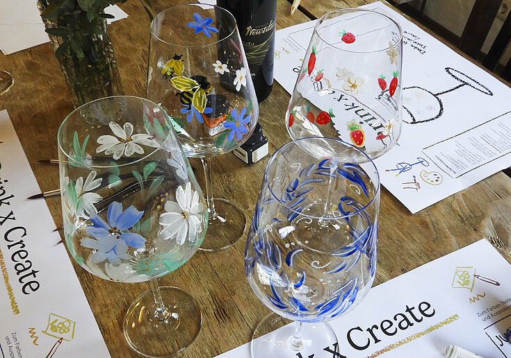 Four painted wine glasses with a variety of patterns.